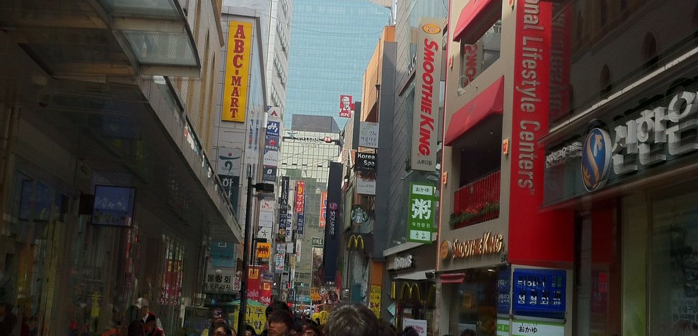 Crowded shopping street in Myeong-dong at dusk, Seoul