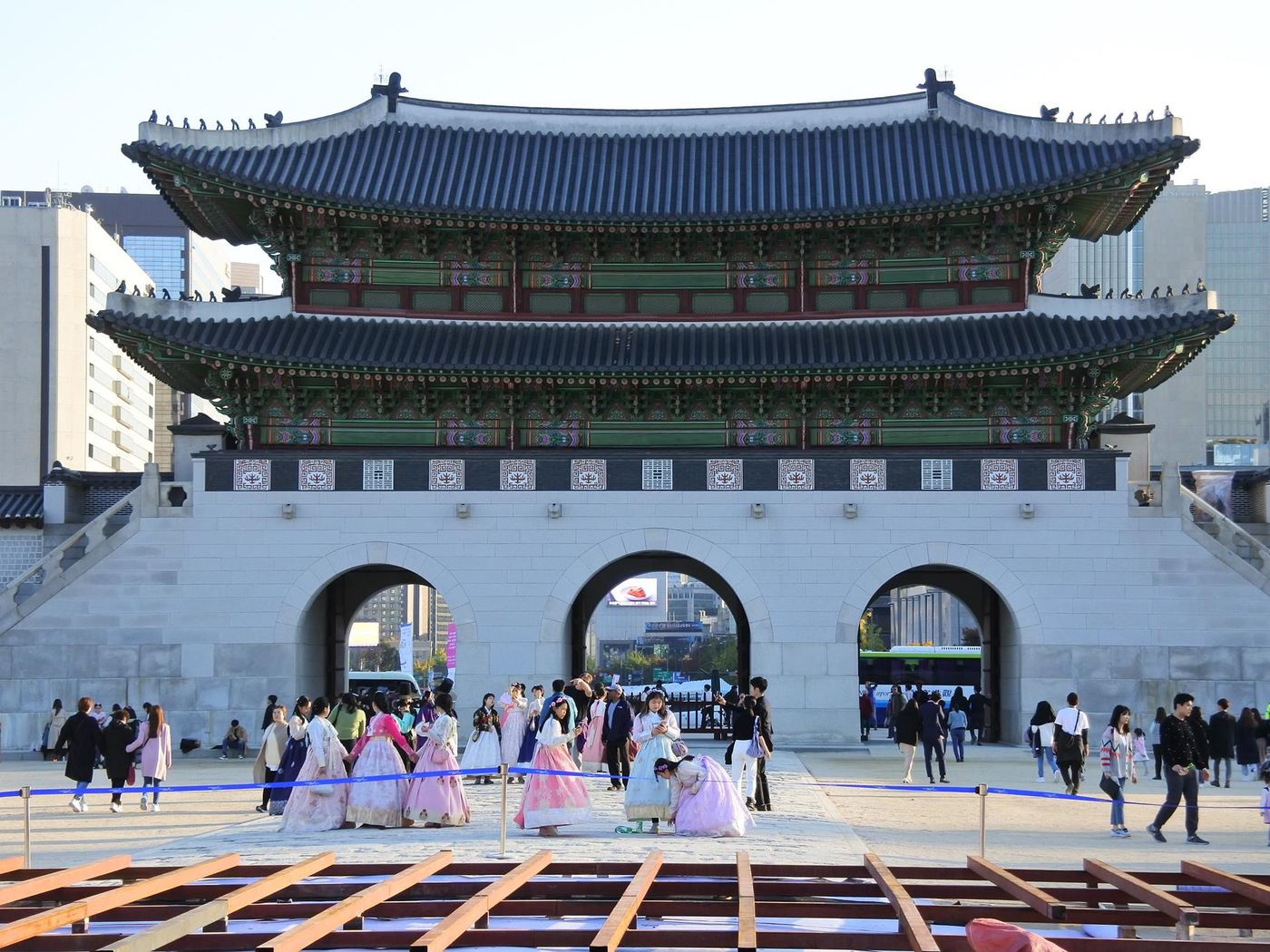 Visitors in hanbok walking in front of Gwanghwamun gate, Seoul